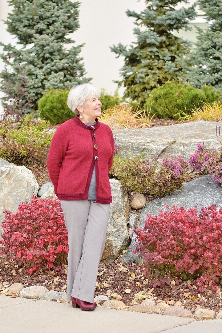 Red cardigan with grey trousers outdoors, bold fall outfit for women over 40