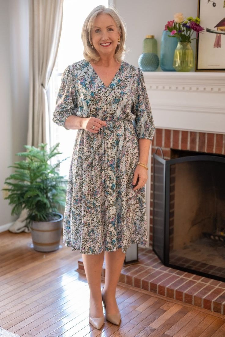 Gray paisley midi dress with three-quarter sleeves by a fireplace, cozy summer elegance for older women