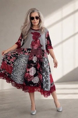 Dark floral midi dress with a gray overlay twirling, dramatic summer look for mature women