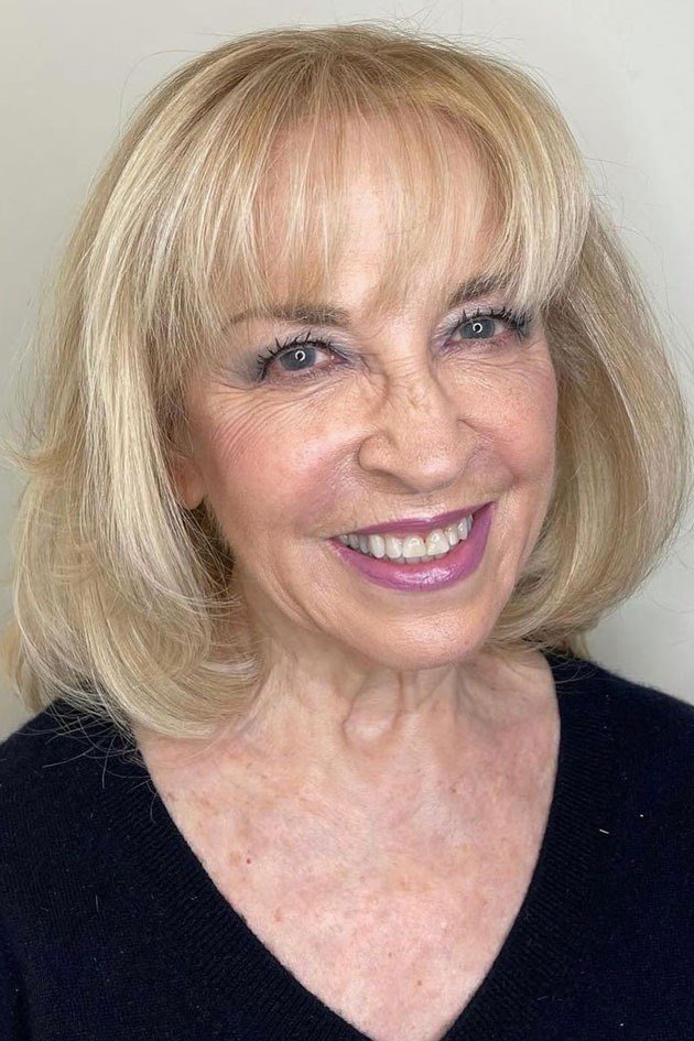 Blonde bob with full bangs on a woman over 60, front view
