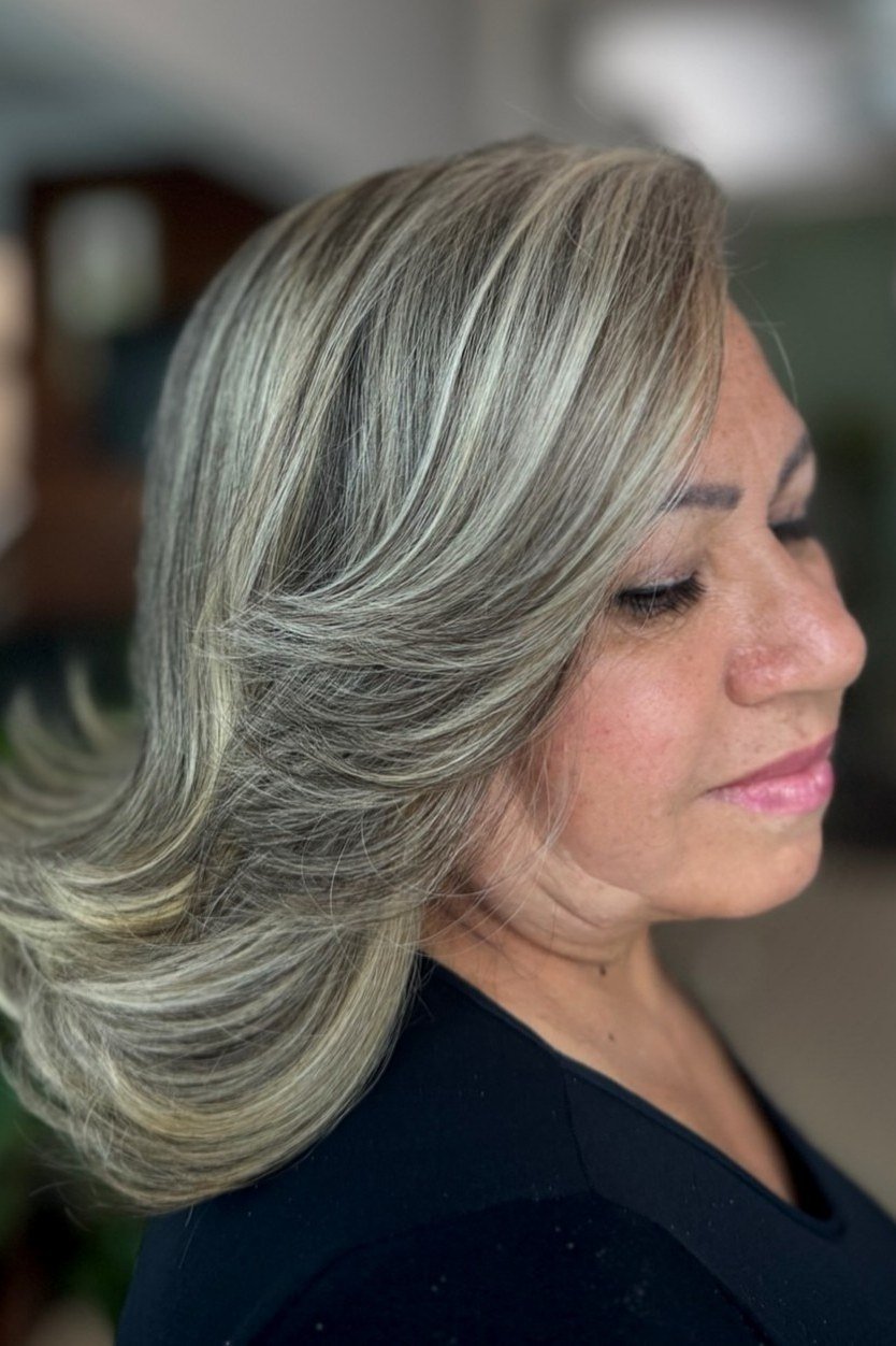 Silver layered lob on a woman over 60, side view