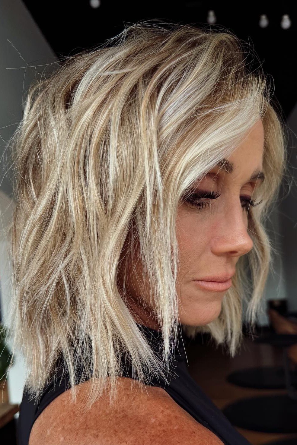 Blonde textured bob on a woman over 60, side view