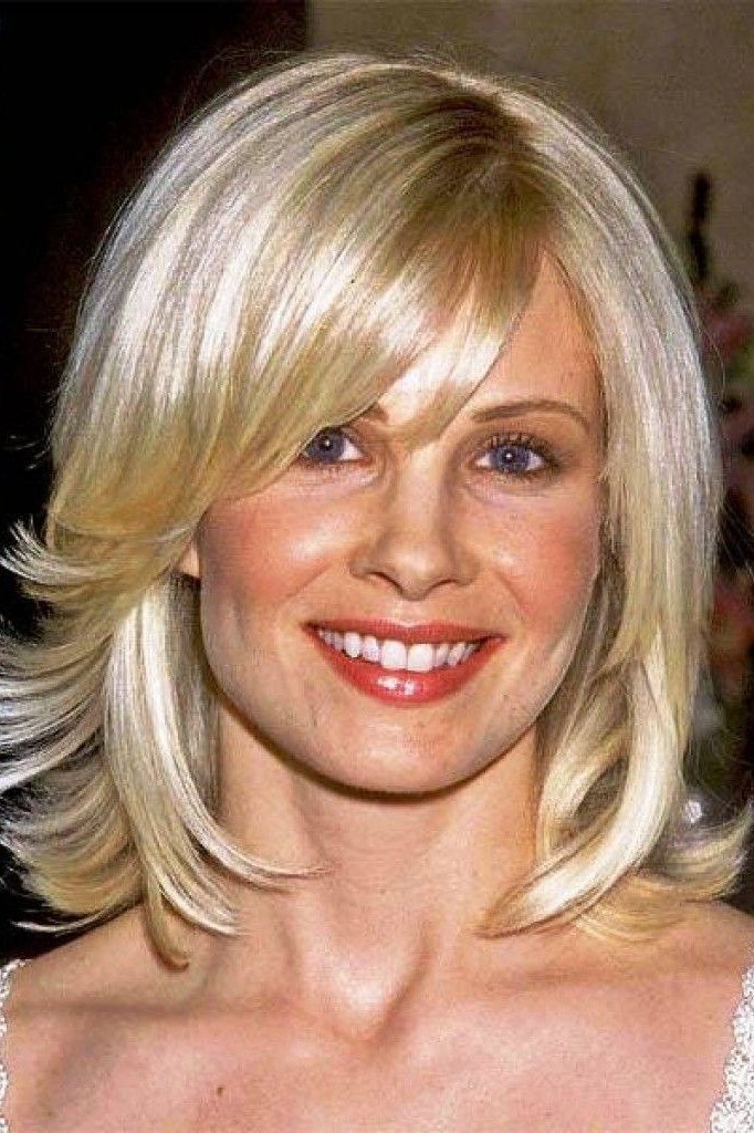 Blonde layered lob on a woman over 60, front view