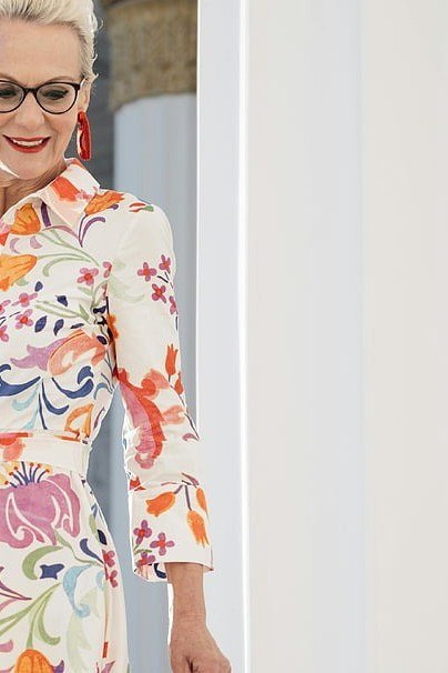 White shirt dress with red floral, gray hair and glasses