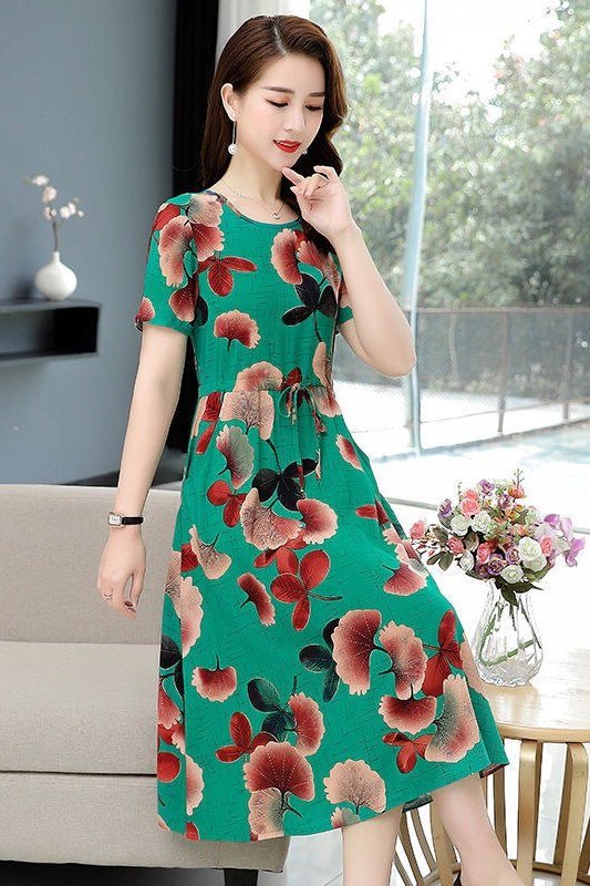 Green midi dress with big red blooms, modern living room