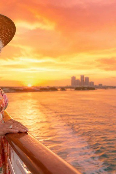 Floral sundress at sunset on cruise deck with straw hat