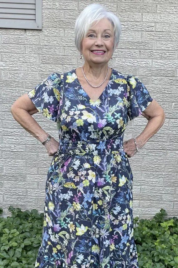 Blue midi dress with yellow floral, white hair, ivy wall