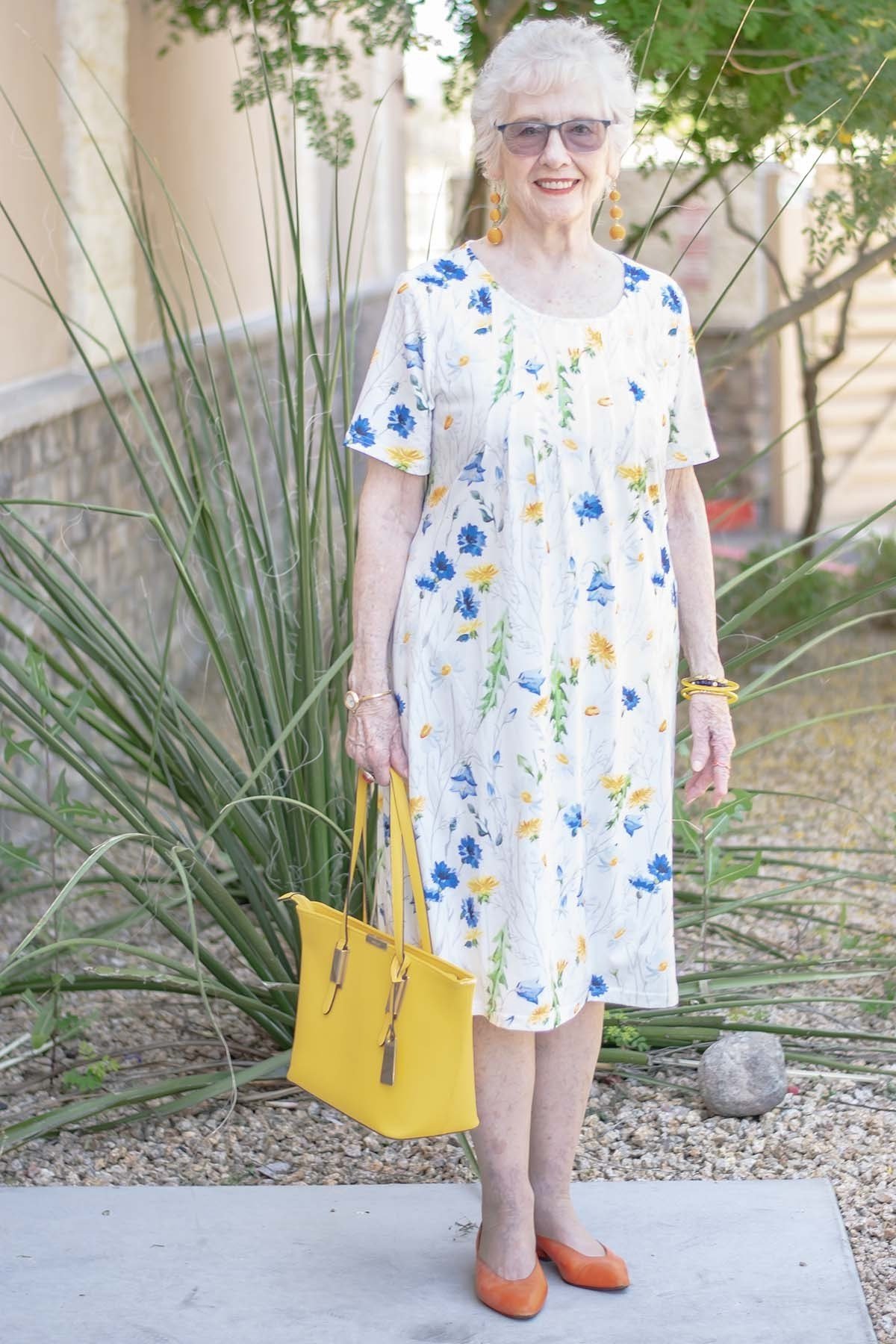 White midi dress with yellow ditsy floral and yellow handbag