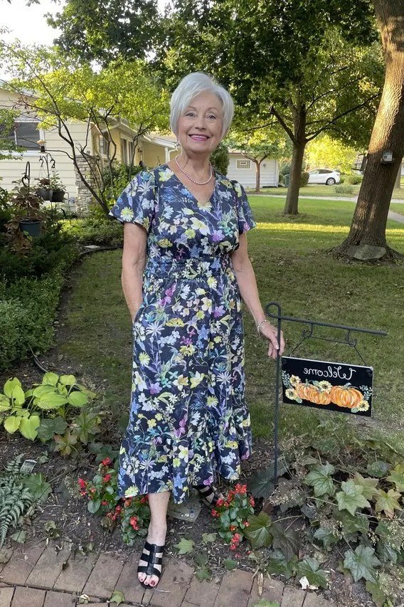 Blue floral midi dress in park, white-haired woman