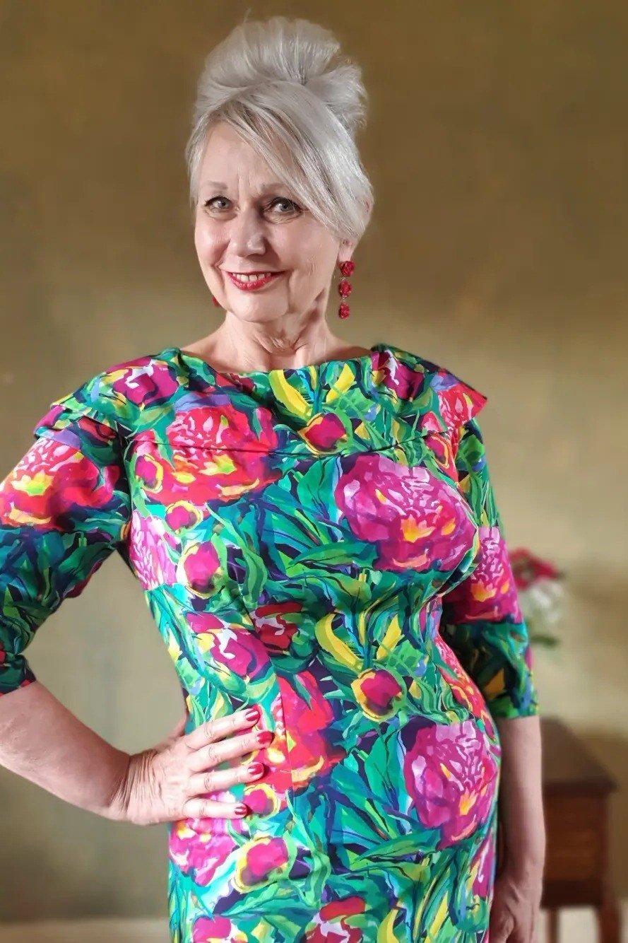 Green sheath dress with pink peony floral, white hair