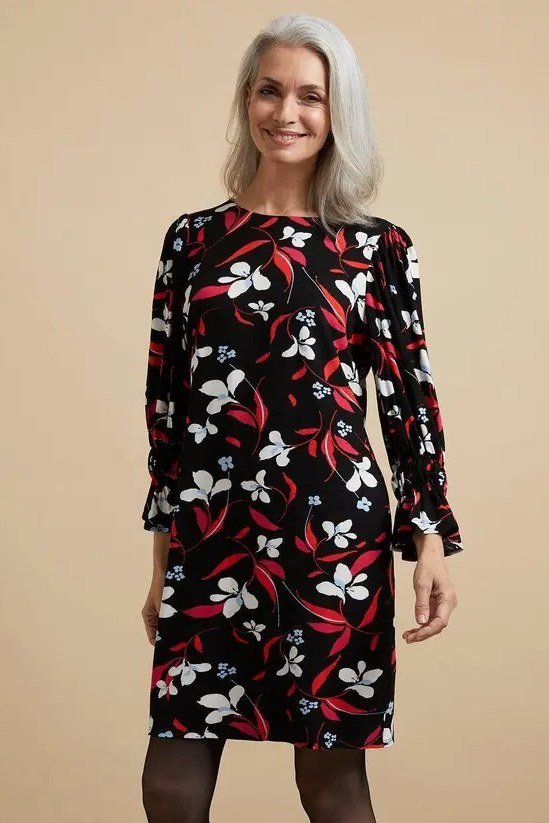 Black sheath dress with white and red floral print