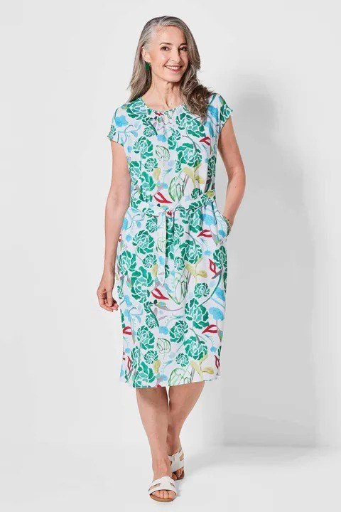Teal sheath dress with green floral print, hallway
