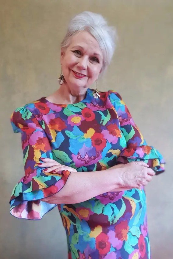 Multicolor floral dress on white-haired woman, studio portrait