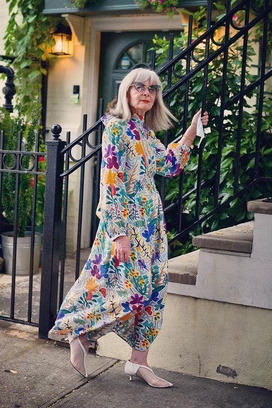 Multicolor floral maxi dress flowing on garden stairs