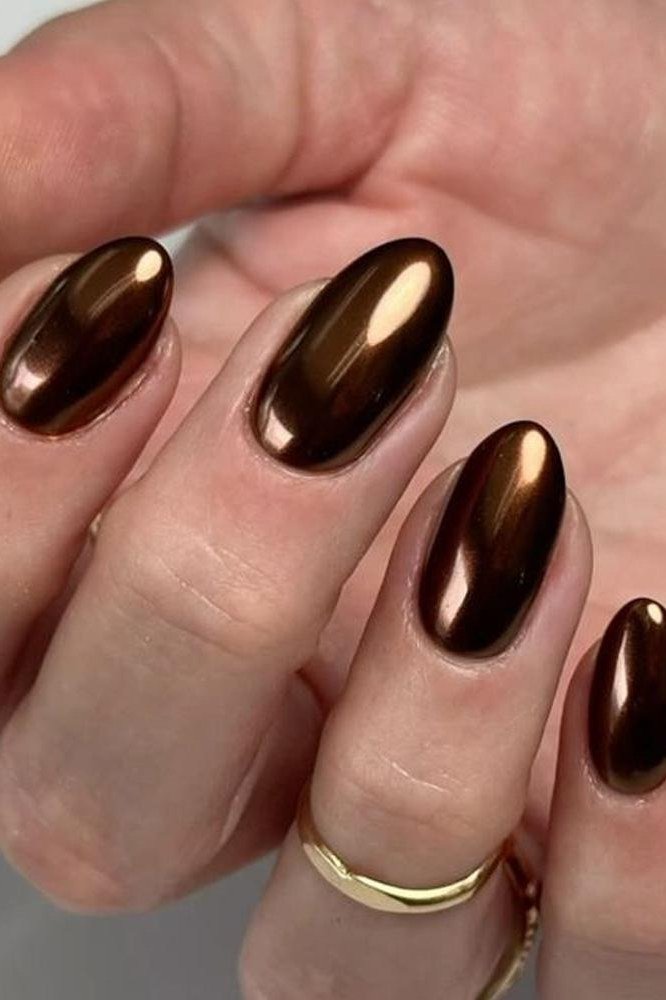 Espresso mirror chrome almond nails, deep brown reflective manicure with gold ring