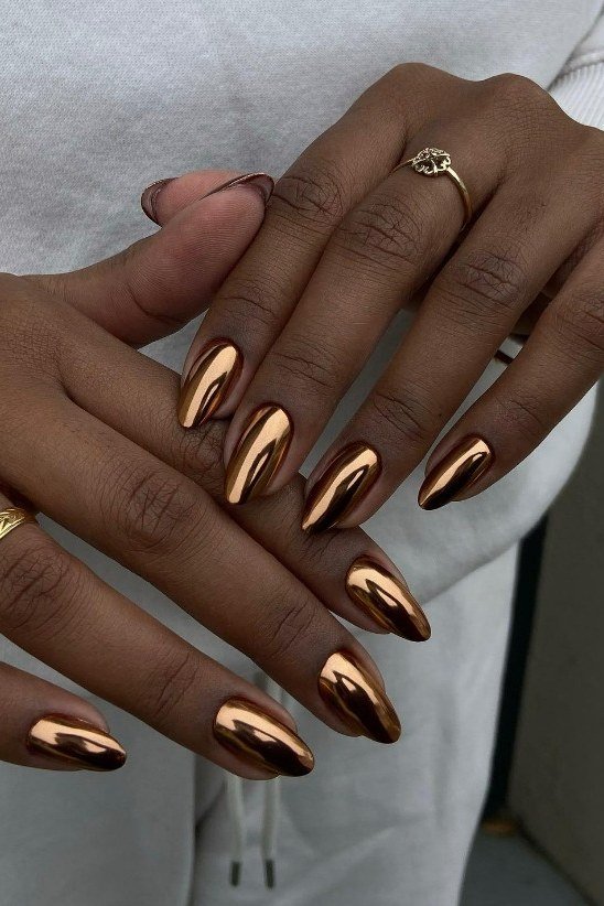 Copper chrome almond nails on deep skin tone
