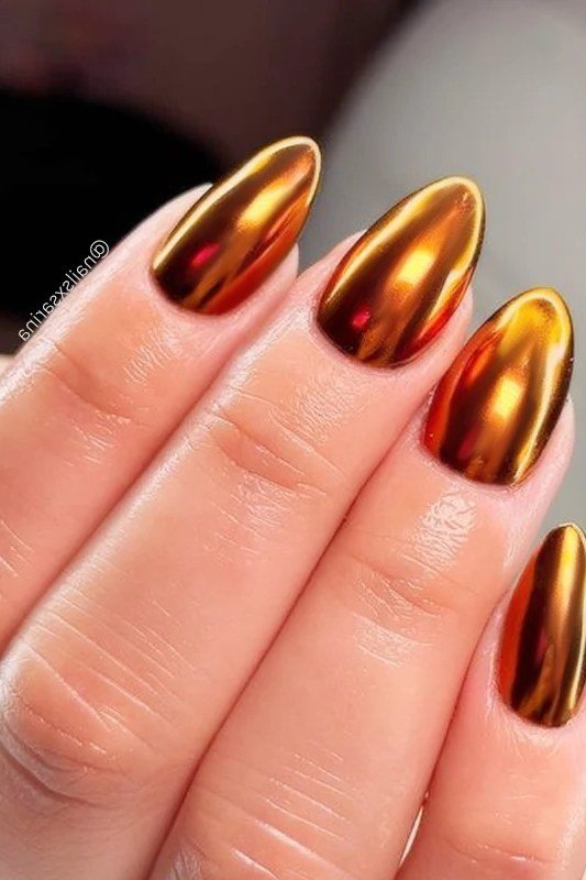 Burnt copper chrome almond nails with deep orange sheen