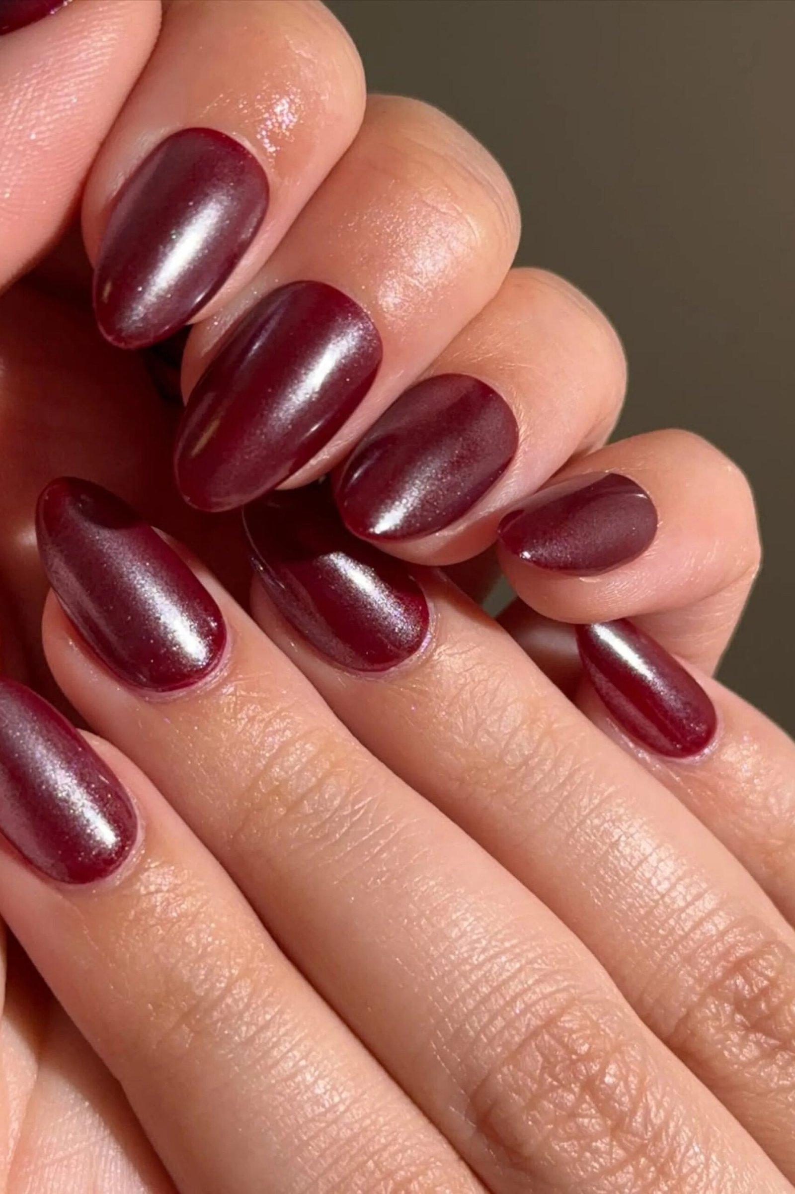 Red violet chrome almond nails, two hands together