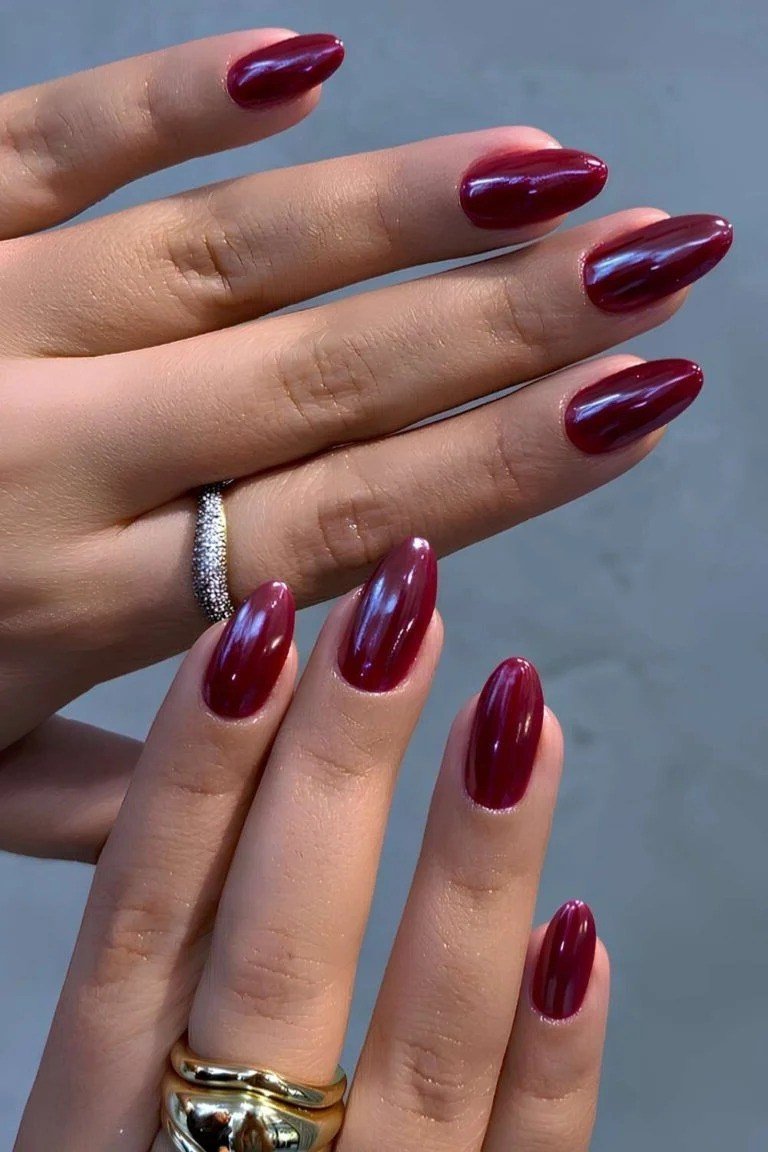 Double-hand drama deep red chrome almond nails with gold rings