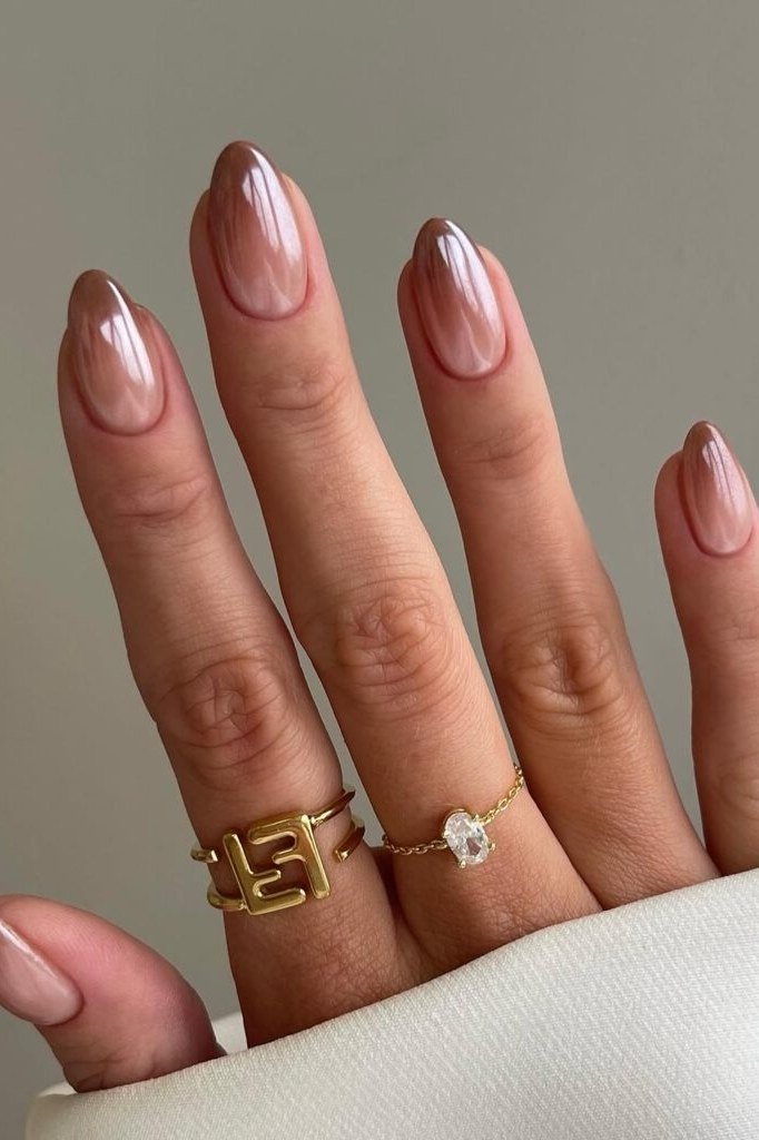 Mauve and gold chrome almond nails with gold rings