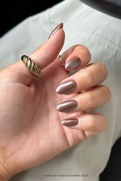 Taupe chrome almond nails with stacked gold rings