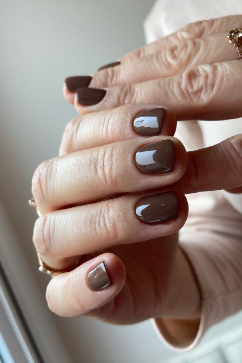 Espresso short and chic dark brown nails on mature hands