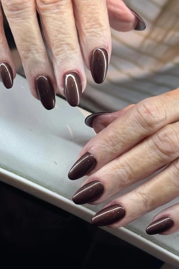 Plum chrome almond nails on mature hands with statement ring
