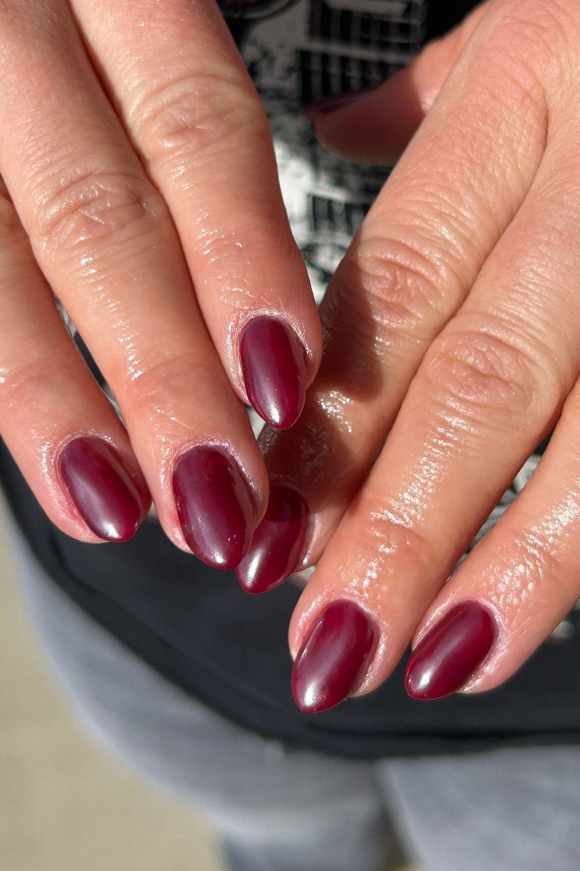 Cherry red comfort short almond nails on mature hands