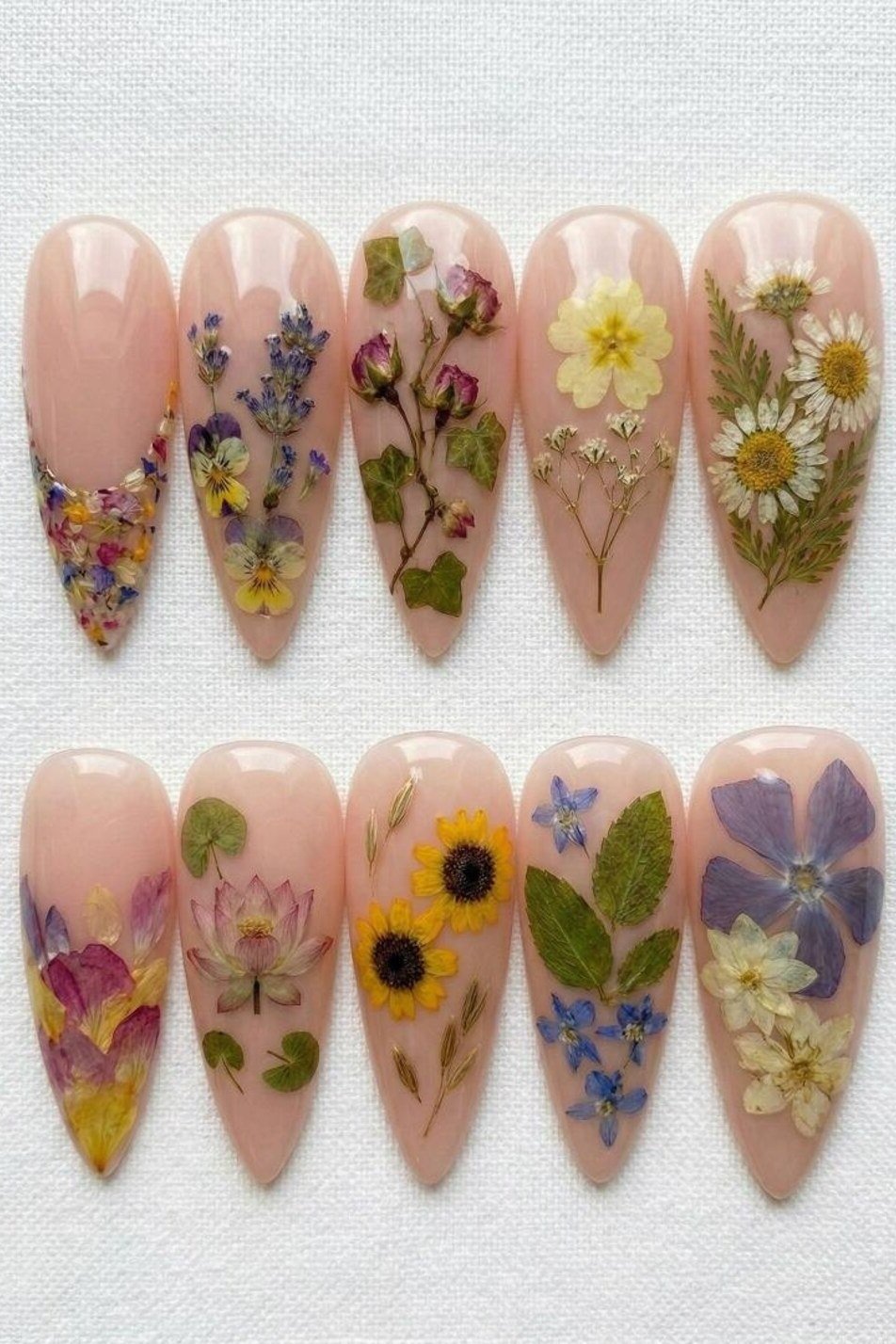 Pressed dried flower nail art on long nude stiletto nails for women over 50