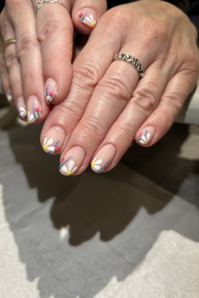 Pink blossom nail art with gold details for women over 50