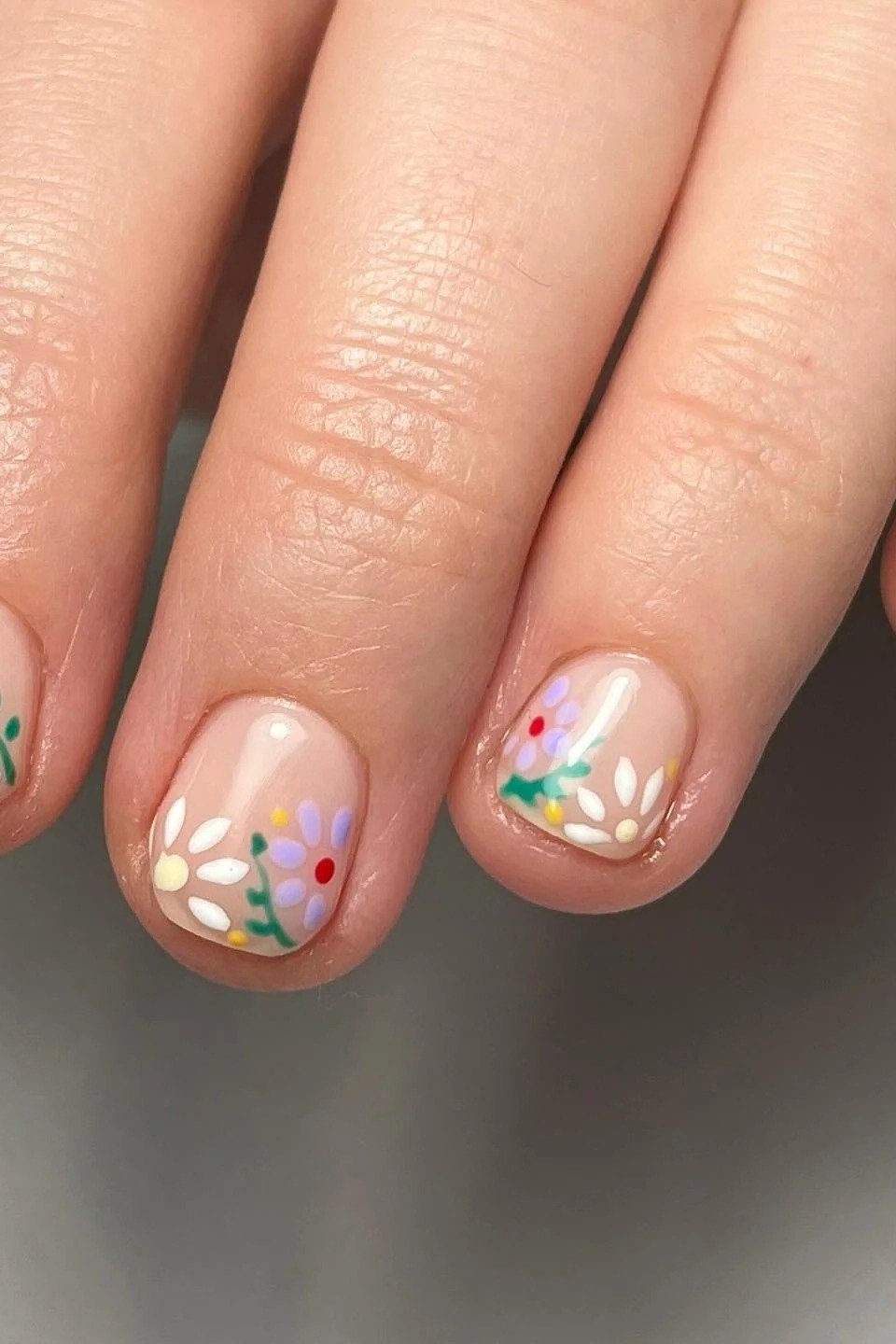 Tiny pink and white daisy nail art for women over 50