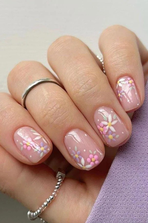 Pink daisy nail art on short square nails for women over 50