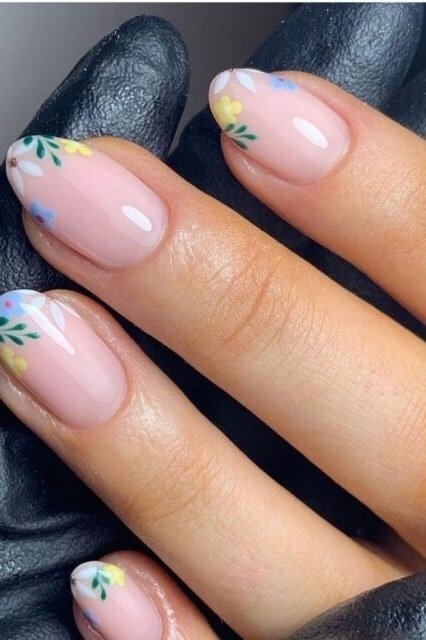 Pink floral nail art on pink base for women over 50
