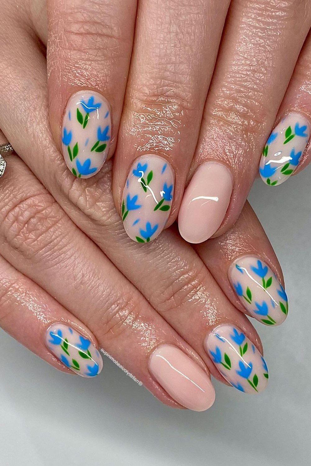 Blue wildflower nail art on almond nails for women over 50