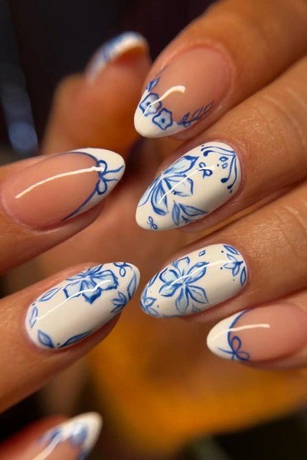 Blue porcelain floral nail art on almond nails for women over 50