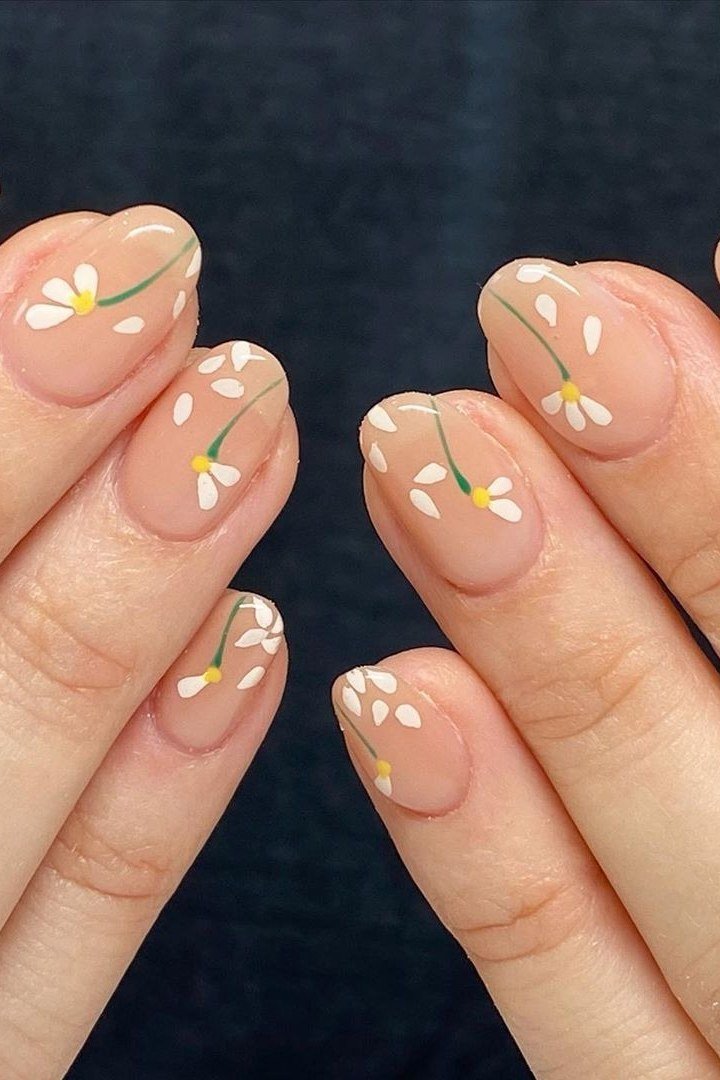 Daisy chain nail art on nude nails for women over 50