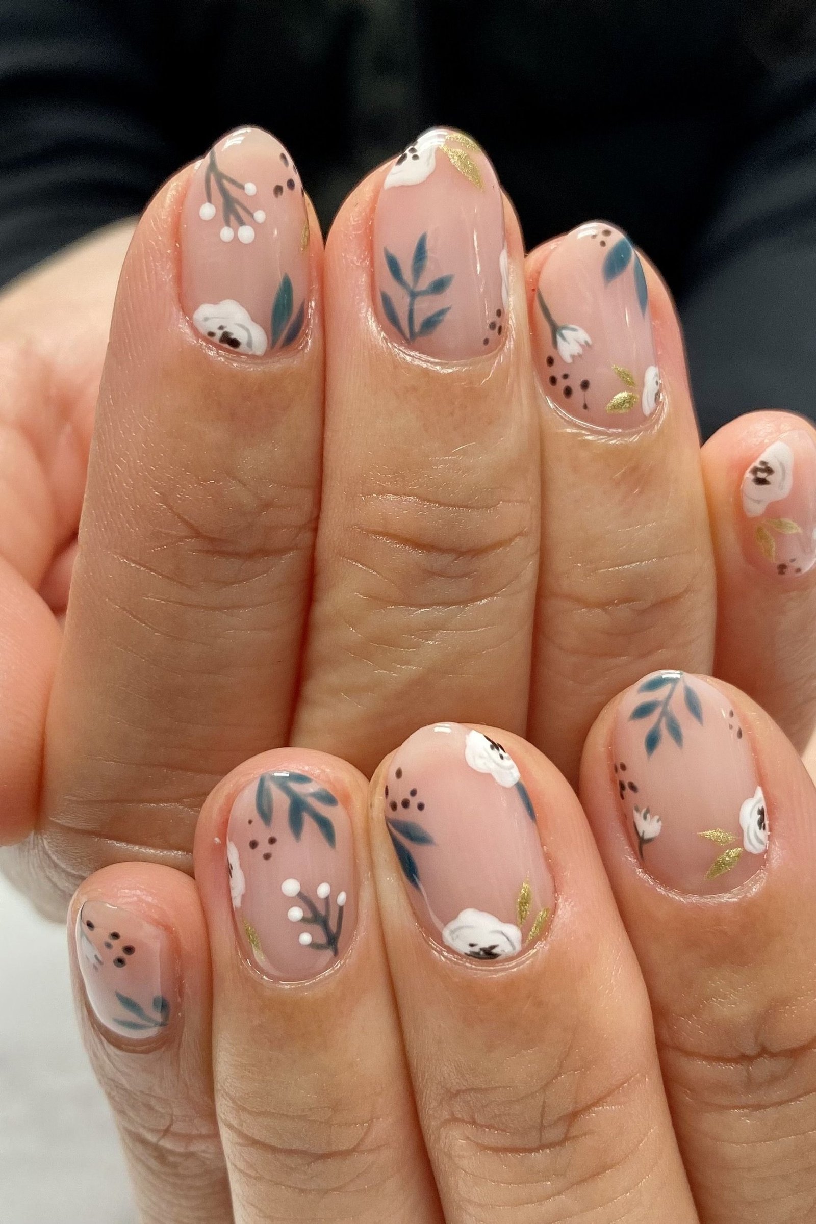Minimal tiny floral nail art on nude nails for women over 50