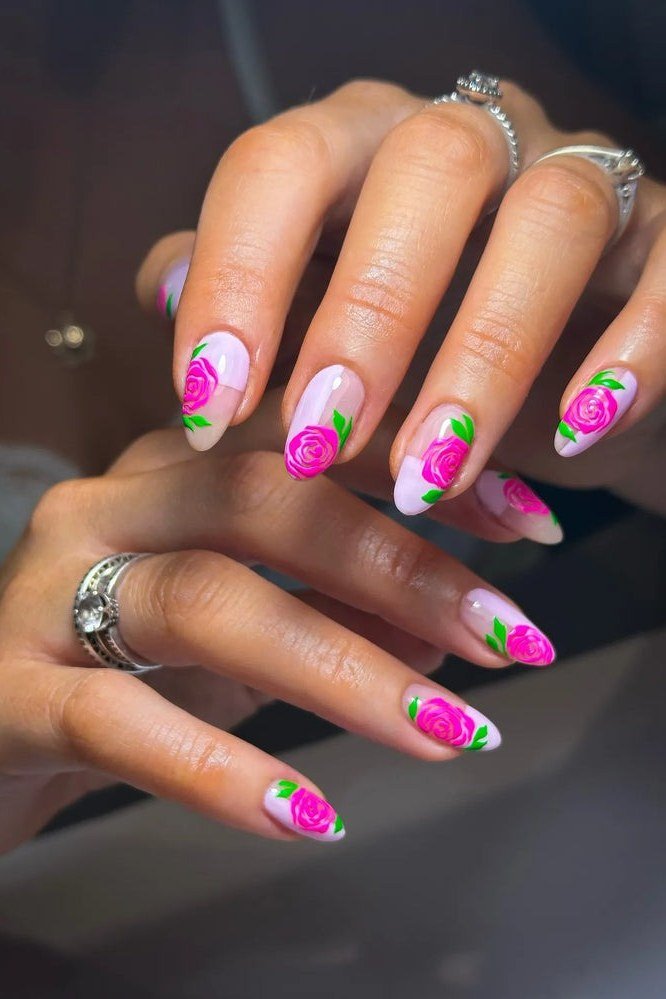 Bright pink floral nail art on white nails for women over 50