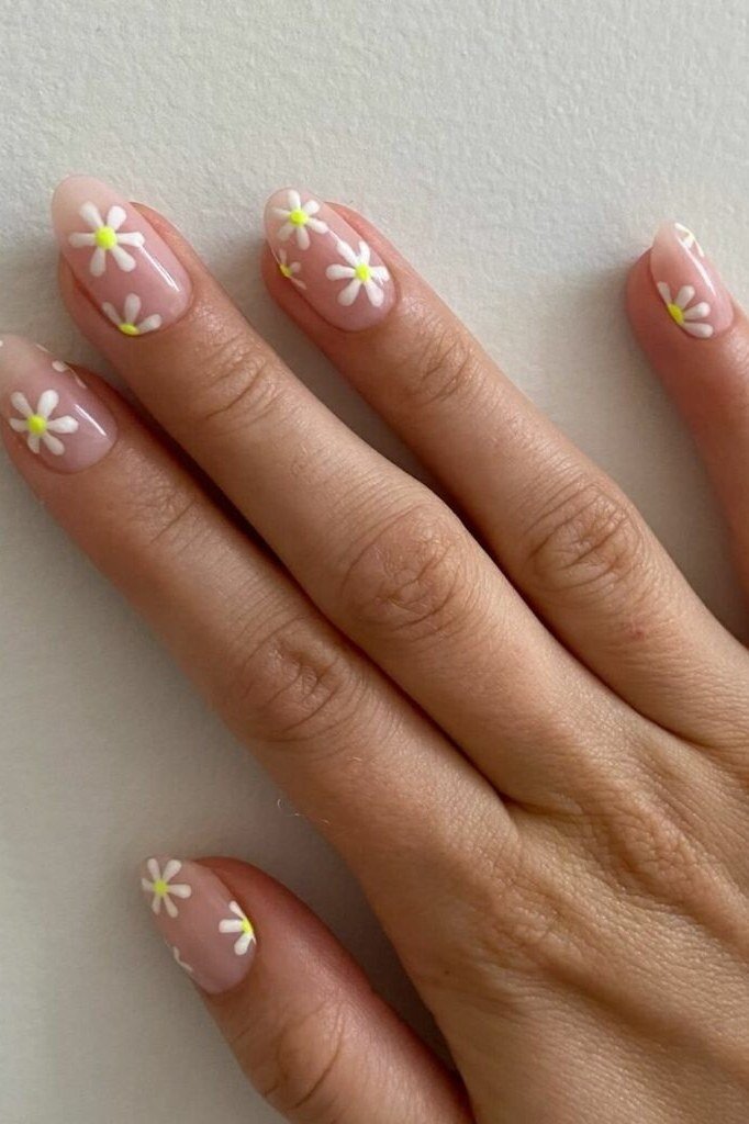 Pink French tip nail art with daisies for women over 50