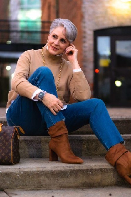 Camel turtleneck sweater, blue jeans, cognac heeled boots, woman on steps