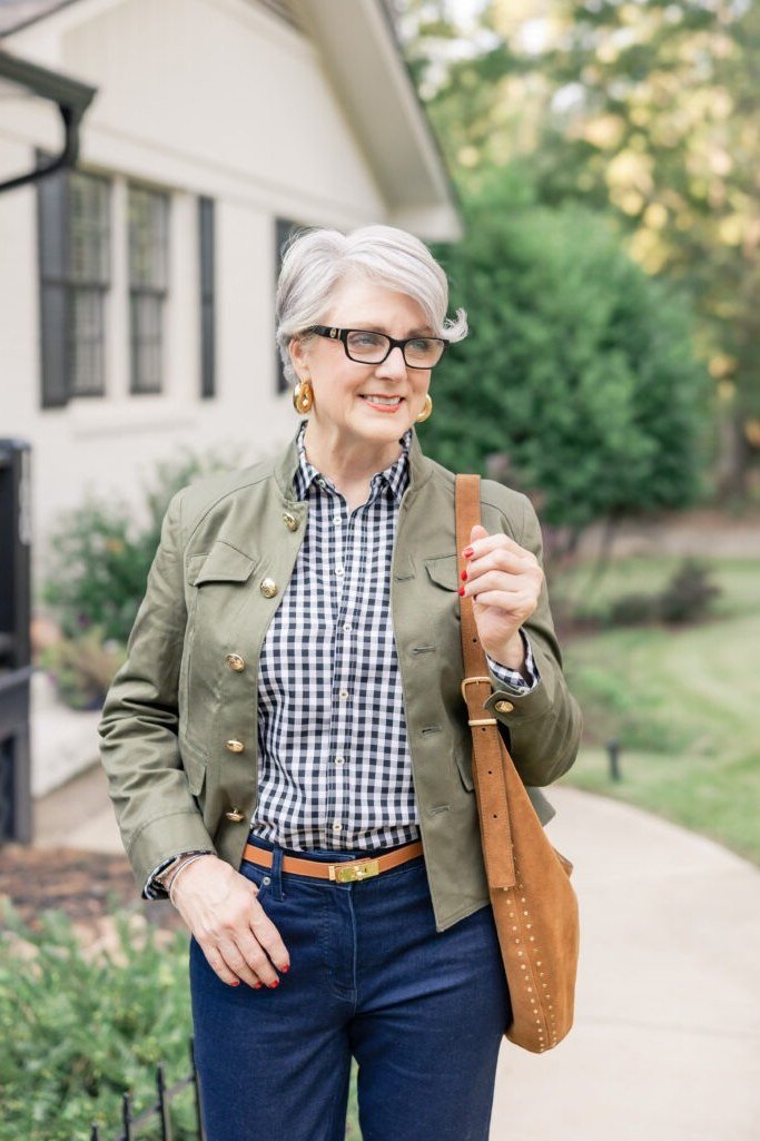 Olive utility jacket, gingham shirt, dark jeans, tan crossbody bag