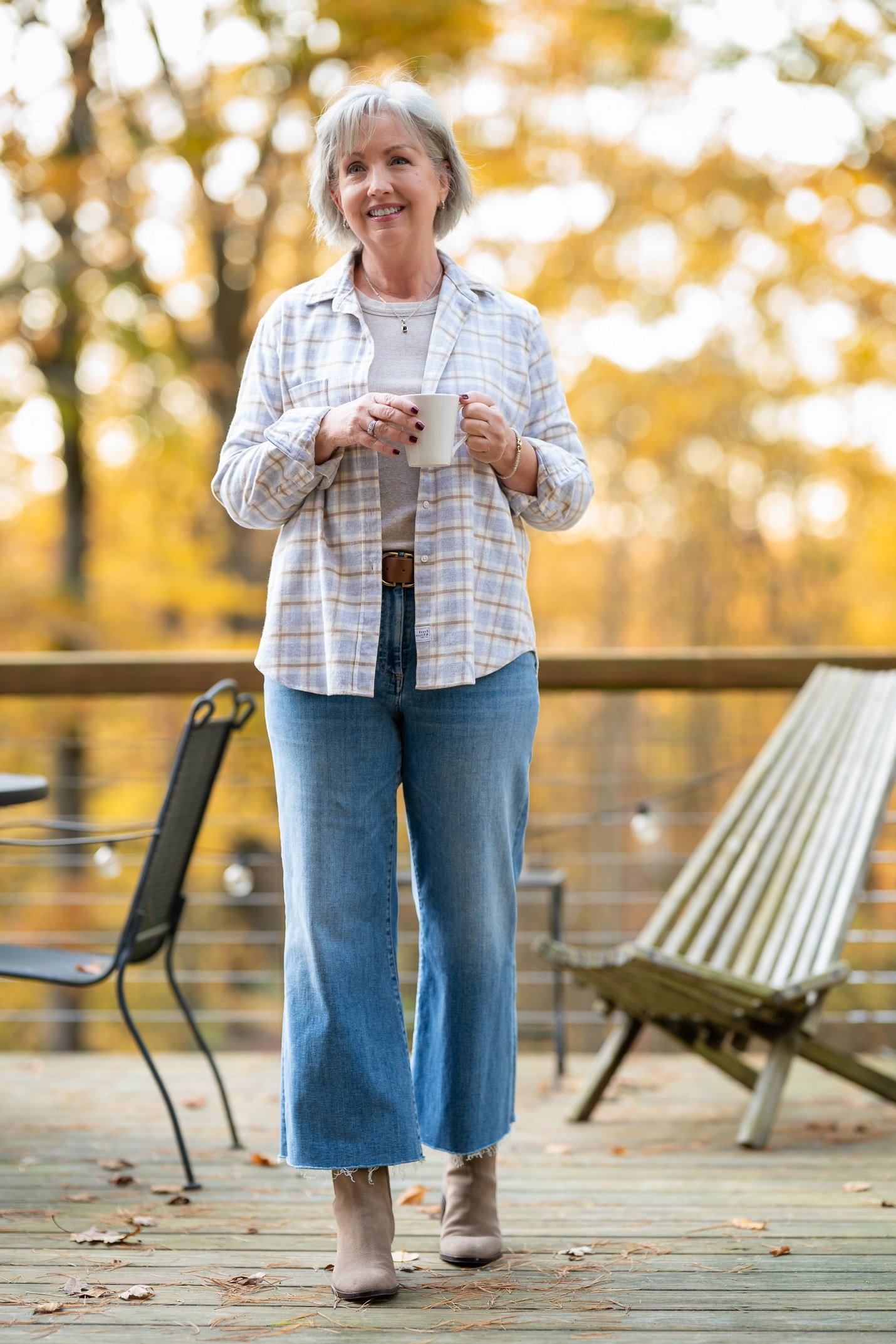 Light plaid shirt, wide-leg cropped jeans, taupe ankle boots, woman on deck