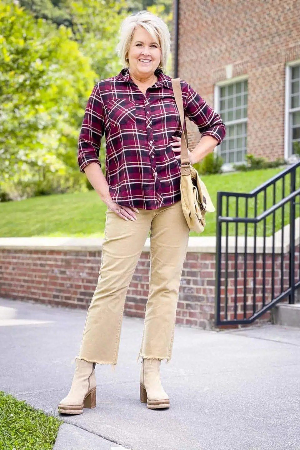 Purple plaid shirt, tan pants, beige boots, woman at brick house