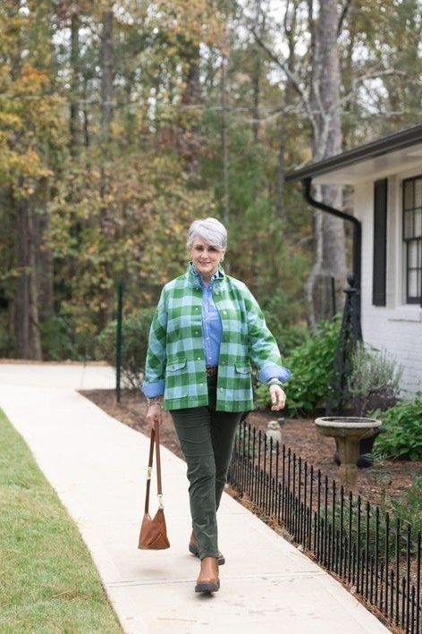 Green plaid flannel shirt, dark green pants, woman on garden path