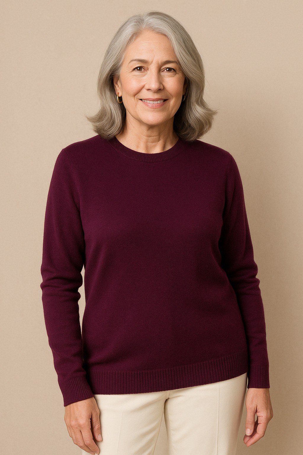 Burgundy crewneck sweater, cream wide-leg pants, woman in studio