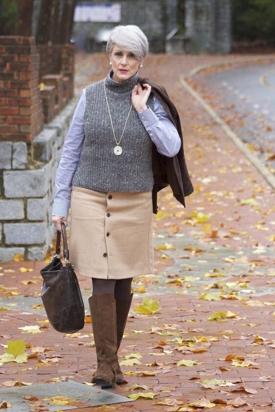 Gray sweater vest, light blue shirt, tan button midi skirt, brown knee boots