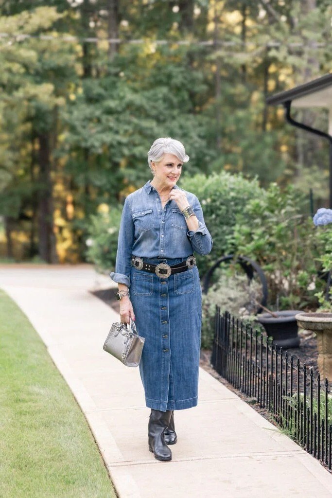 Chambray shirt, denim midi skirt, wide belt, dark boots, woman on path