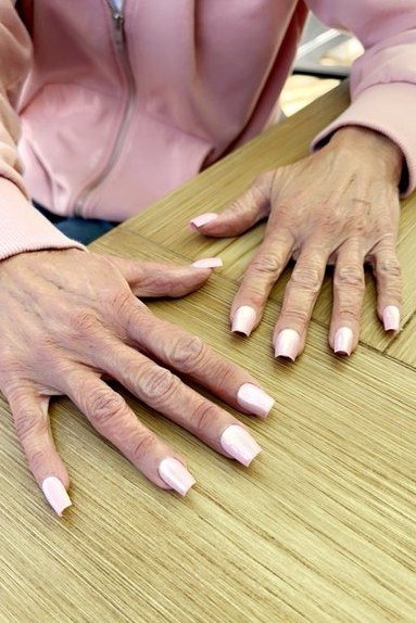 Long Almond French Tips on Wood, french tip nails for women over 70, elegant manicure on mature hands