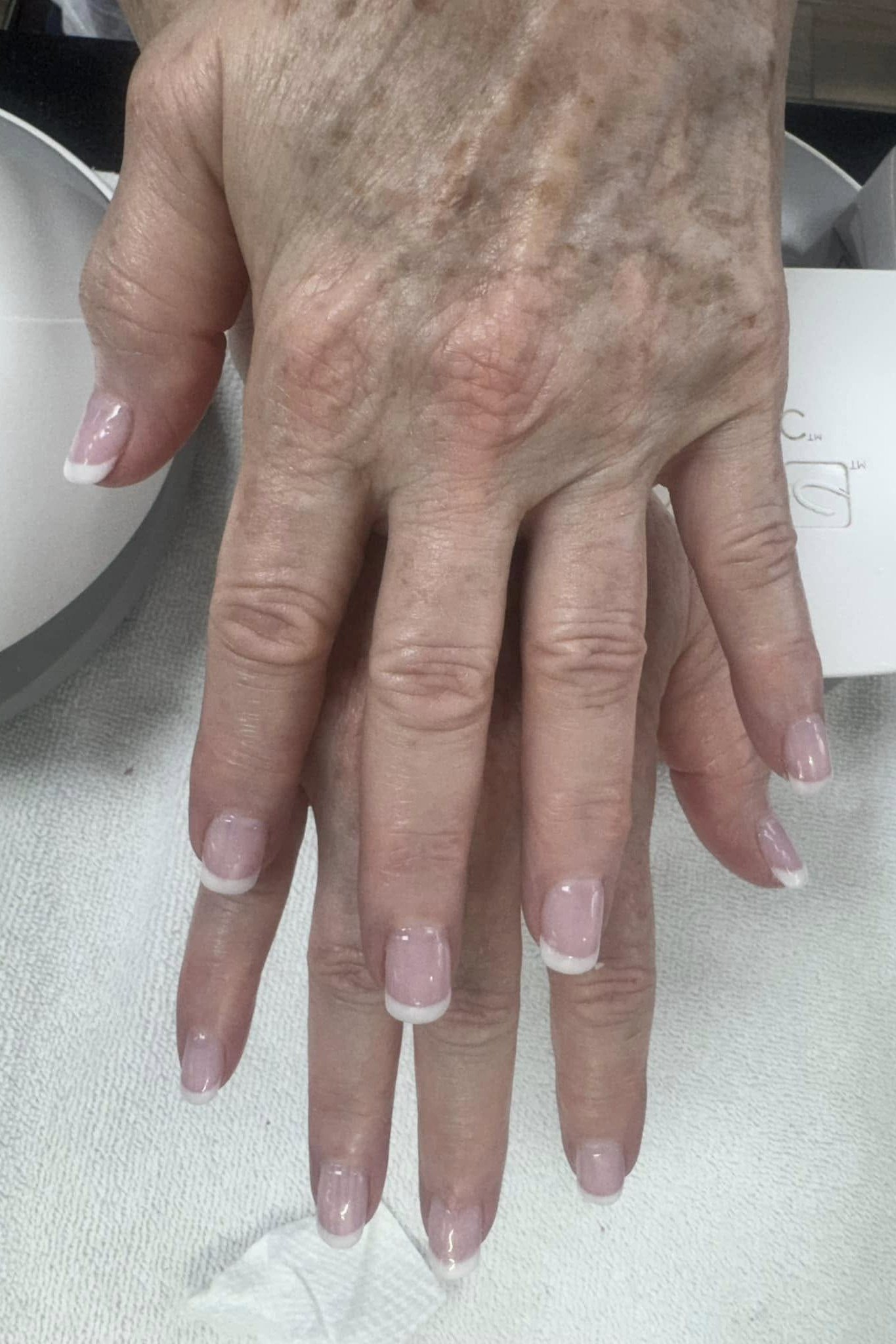 Short French Tips, french tip nails for women over 70, elegant manicure on mature hands
