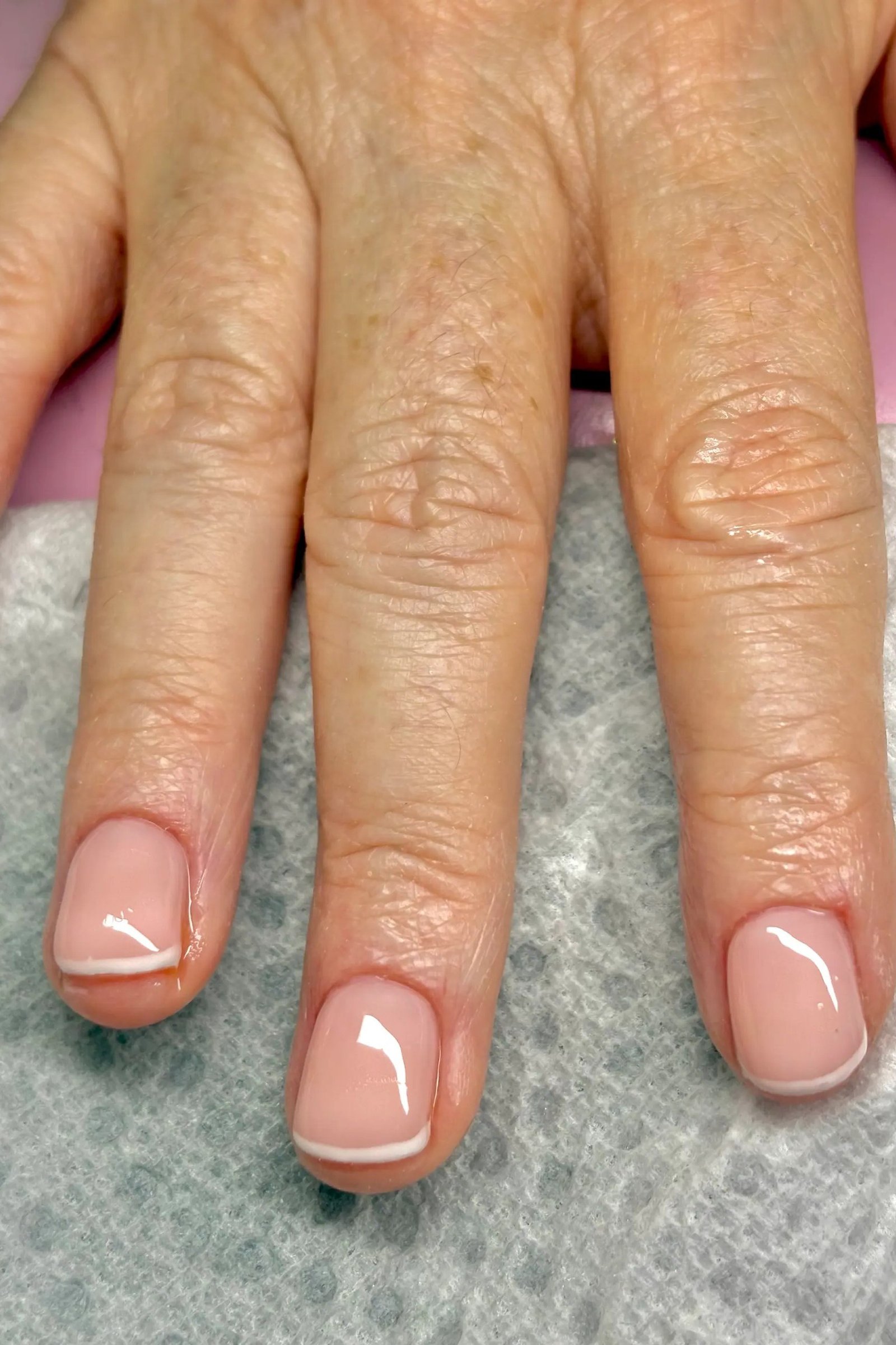Milky Short Pink French Tips, french tip nails for women over 70, elegant manicure on mature hands